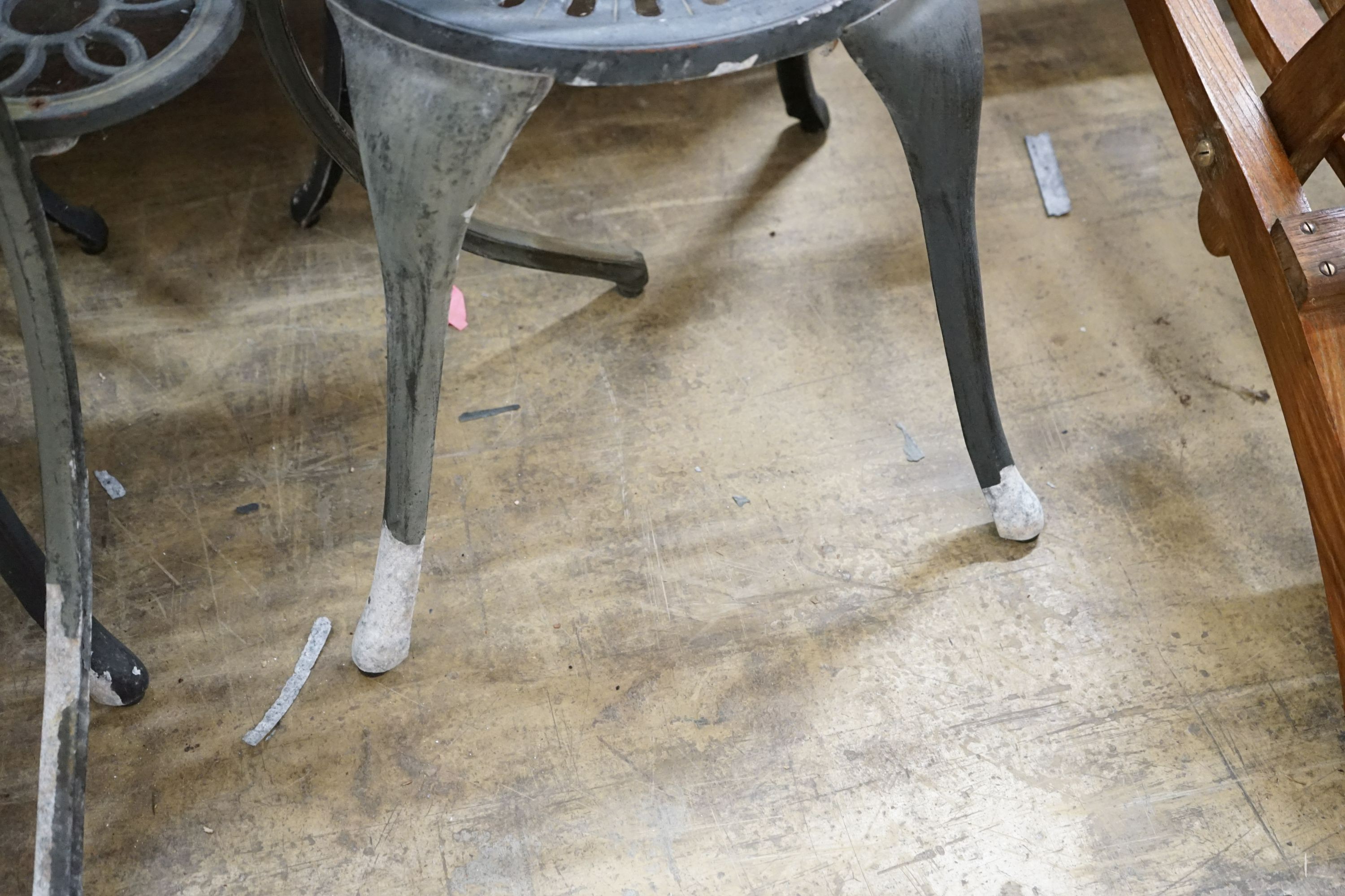 A circular aluminium garden table, diameter 69cm, height 67cm and two chairs